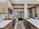 Bright kitchen featuring wooden cabinets, white countertops, stainless appliances, and unique stained glass doors at 2004 Magnolia Ave, Sanford, FL 32771