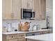 Well-lit kitchen features stainless steel microwave and white countertops on wooden cabinets at 2004 Magnolia Ave, Sanford, FL 32771