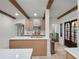 Bright kitchen featuring wooden cabinets, white countertops, stainless appliances, decorative beams, and stained glass doors at 2004 Magnolia Ave, Sanford, FL 32771
