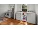Bright laundry room features wood flooring, a washer and dryer, utility sink, and a water heater at 2004 Magnolia Ave, Sanford, FL 32771