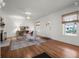 Living room featuring hardwood floors, neutral tones, and natural light from large windows at 2004 Magnolia Ave, Sanford, FL 32771