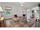 Bright living room featuring hardwood floors, neutral tones, and natural light from large windows at 2004 Magnolia Ave, Sanford, FL 32771