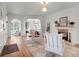Bright living room featuring hardwood floors, a fireplace, and neutral decor, with a view into another living space at 2004 Magnolia Ave, Sanford, FL 32771
