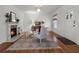 Cozy living room featuring hardwood floors, a fireplace, and neutral decor, with a view out to the entrance door at 2004 Magnolia Ave, Sanford, FL 32771