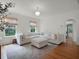 Cozy living room with hardwood floors, natural light, and a comfortable white sectional sofa at 2004 Magnolia Ave, Sanford, FL 32771