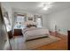 Bright main bedroom with hardwood floors, large bed, and windows that offer plenty of natural light at 2004 Magnolia Ave, Sanford, FL 32771