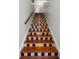 Straight-on view of a staircase with colorful, decorative Spanish tiles on each step at 2004 Magnolia Ave, Sanford, FL 32771