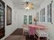 Charming sunroom with wicker chairs, a round table, and large windows offering an abundance of natural light at 2004 Magnolia Ave, Sanford, FL 32771