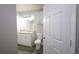 Bright bathroom featuring a marble vanity, white cabinets, and a toilet at 202 E South St # 1042, Orlando, FL 32801