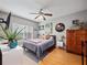 Comfortable bedroom with light walls, a ceiling fan, and a large window offering plenty of natural light at 204 E South St # 2052, Orlando, FL 32801