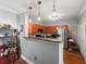Bright eat-in kitchen features wood cabinets, sleek countertops, stainless steel refrigerator, and pendant lighting at 204 E South St # 2052, Orlando, FL 32801