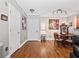 Spacious living room showcases hard wood flooring, a large entrance door, and a connected dining space at 204 E South St # 2052, Orlando, FL 32801