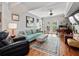 Cozy living room with blue couch, ottoman, area rug, and a french door at 204 E South St # 2052, Orlando, FL 32801