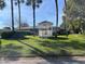 White gazebo in a grassy area of the community at 208 Diamond Cv # 104, Casselberry, FL 32707
