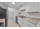 Well-equipped kitchen featuring white cabinets, granite countertops, and stainless steel appliances at 208 Diamond Cv # 104, Casselberry, FL 32707