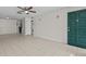 Open living space with tile floors, a ceiling fan, and views into the kitchen at 208 Diamond Cv # 104, Casselberry, FL 32707