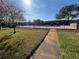 Relaxing pool area with surrounding lawn and path at 208 Diamond Cv # 104, Casselberry, FL 32707