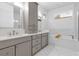 Elegant bathroom with double vanity, marble tile, and a soaking tub at 2309 Depauw Ave, Orlando, FL 32804