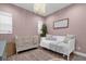 Charming Bedroom with crib, sofa, and neutral color palette at 2309 Depauw Ave, Orlando, FL 32804