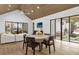 Dining area with vaulted ceilings, hardwood floors, a view into the living room, and access to outdoor spaces at 2309 Depauw Ave, Orlando, FL 32804