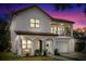 Charming two-story home featuring a tile roof, balcony, arched entryway, and a well-manicured front yard at 2309 Depauw Ave, Orlando, FL 32804