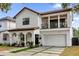 Two-story house with white exterior, brown roof and a two-car garage at 2309 Depauw Ave, Orlando, FL 32804