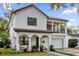 Two-story house with a white exterior, brown roof, and a two-car garage at 2309 Depauw Ave, Orlando, FL 32804