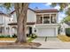 Two-story house with white exterior, brown roof and a two-car garage at 2309 Depauw Ave, Orlando, FL 32804