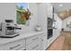 Modern kitchen features white cabinets, marble countertops, and high-end appliances at 2309 Depauw Ave, Orlando, FL 32804