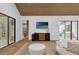 Open living area with vaulted ceilings, hardwood floors, and access to patio at 2309 Depauw Ave, Orlando, FL 32804
