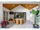 Cozy outdoor dining area with a vaulted wood ceiling, wicker chairs, and view of the backyard at 2309 Depauw Ave, Orlando, FL 32804