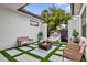 Inviting outdoor patio with artificial grass, modern seating, and privacy fencing at 2309 Depauw Ave, Orlando, FL 32804