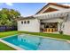 Inviting swimming pool in backyard with artificial turf and patio furniture at 2309 Depauw Ave, Orlando, FL 32804