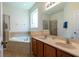 Bright bathroom features double sinks, a large soaking tub and glass enclosed shower at 2553 Dharma Cir, Kissimmee, FL 34746