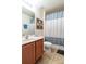 Clean bathroom with shower/tub combo and wood vanity at 2553 Dharma Cir, Kissimmee, FL 34746
