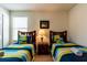 Bedroom with twin beds and nightstand at 2553 Dharma Cir, Kissimmee, FL 34746