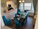 Bright dining room with a large table and teal chairs at 2553 Dharma Cir, Kissimmee, FL 34746