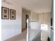 Upstairs hallway with white railing and carpeted floors at 2553 Dharma Cir, Kissimmee, FL 34746