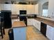 Modern kitchen with white cabinets and an island at 2553 Dharma Cir, Kissimmee, FL 34746