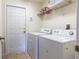 Laundry room with washer, dryer, and extra storage at 2553 Dharma Cir, Kissimmee, FL 34746