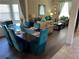 Open-concept living and dining area with view to the living area and blue accents at 2553 Dharma Cir, Kissimmee, FL 34746