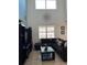 Spacious living room featuring a sectional sofa, large TV, and ample natural light at 2553 Dharma Cir, Kissimmee, FL 34746