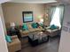 Living room with hardwood floors, neutral color palette and natural lighting at 2553 Dharma Cir, Kissimmee, FL 34746