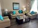 Bright living room featuring a comfortable sofa and accent chairs at 2553 Dharma Cir, Kissimmee, FL 34746