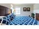 Bright main bedroom with king-size bed and patterned bedding at 2553 Dharma Cir, Kissimmee, FL 34746