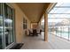 Covered patio with outdoor dining set and pool view at 2553 Dharma Cir, Kissimmee, FL 34746