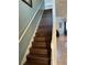 Elegant staircase with dark wood flooring and white railing at 2553 Dharma Cir, Kissimmee, FL 34746