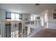 Upstairs hallway features white railing, 2 windows and artwork at 2553 Dharma Cir, Kissimmee, FL 34746