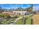Aerial view of a rural property with barn, fences, and a long driveway at 26225 Pitts Rd, Eustis, FL 32736