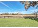 Spacious backyard with a wooden fence and open pasture views at 26225 Pitts Rd, Eustis, FL 32736
